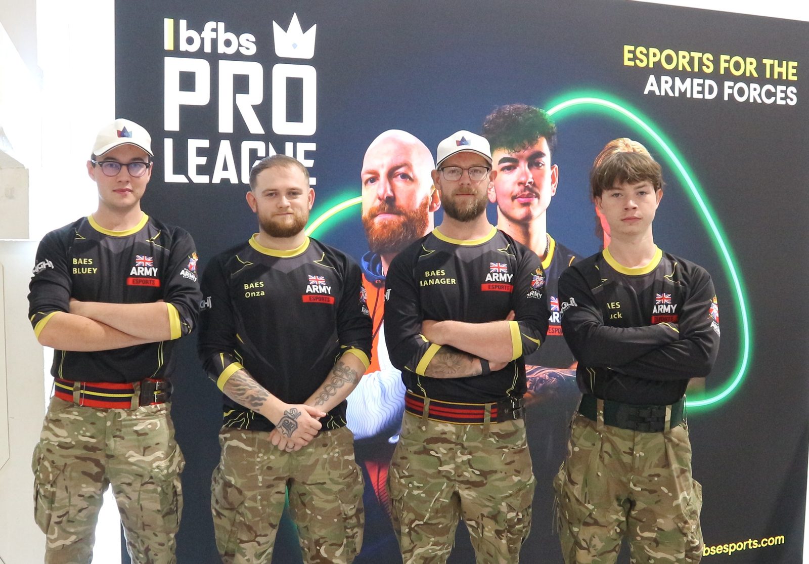 The BAES Buzzards and their manager in front of a BFBS Pro League banner
